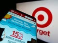 Mobile phone with website of US retail company Target Corporation on screen in front of business logo.