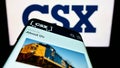 Mobile phone with website of US transportation company CSX Corporation on screen in front of business logo. Royalty Free Stock Photo