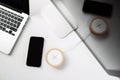 Mobile phone and wireless charger on office table Royalty Free Stock Photo