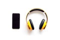 Mobile phone and wireless headphones as gadgets for listen to the music on white background top view Royalty Free Stock Photo