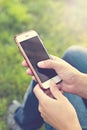 Mobile phone in woman's hand in a deckchair against the background of the river. Telephone, Deckchair, green grass, river. Time t Royalty Free Stock Photo