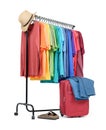 Mobile rack with colorful clothes and a suitcase on white background. File contains a path to isolation Royalty Free Stock Photo
