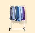 Mobile rack with shirts isolated on light yellow background. File contains a path to isolation Royalty Free Stock Photo