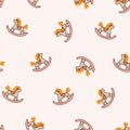 Rocking horses on the pink background. Seamless pattern for children fabric design or nursery wallpaper. Vector illustration in ha