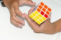 Mobile Rubik`s cube on a white background with expertise. And h