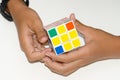 Mobile Rubik`s cube on a white background with expertise. And h