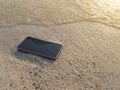 Mobile smart phone on the sandy beach with soft waves of sea background. Internet of things concept Royalty Free Stock Photo