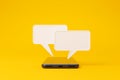 Mobile smartphone and speech bubble chat on yellow background Royalty Free Stock Photo