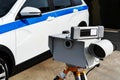 Mobile speed radar on the background of a police car. Traffic safety control of cars on a suburban highway. Close-up Royalty Free Stock Photo