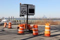 Mobile speed restriction sign and traffic barrels on a tarmac, Brooklyn, NY