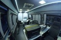 Mobile state administrative services office set in the interior of mini bus: laptops, monitors, phones, printer and