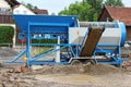 A mobile stone crusher or building rubble shredder for crushing construction material, stones and bricks