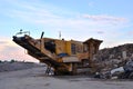 Mobile Stone crusher machine by the construction site or mining quarry for crushing old concrete slabs into gravel Royalty Free Stock Photo