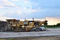 Mobile Stone crusher machine by the construction site or mining quarry for crushing old concrete slabs into gravel Royalty Free Stock Photo