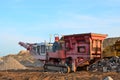 Mobile Stone crusher machine by the construction site or mining quarry for crushing old concrete slabs into gravel and subsequent