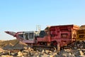 Mobile Stone crusher machine by the construction site or mining quarry for crushing old concrete slabs into gravel and subsequent Royalty Free Stock Photo