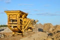 Mobile Stone crusher machine by the construction site or mining quarry for crushing old concrete slabs into gravel and subsequent Royalty Free Stock Photo