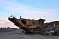 Mobile Stone crusher machine by the construction site or mining quarry for crushing old concrete slabs