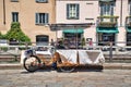 Mobile sunglasses stand tricycle on the side of Navigli Grand canal