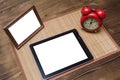 Tablet computer with blank screen and photo frame with copy space. Royalty Free Stock Photo