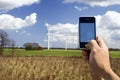 Mobile telephone and wind farm Royalty Free Stock Photo