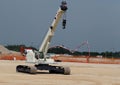 Mobile telescopic crane with tracks in a construction site. Royalty Free Stock Photo