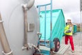 Mobile toilet being loaded on delivery truck