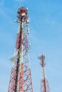 Mobile tower antennas with blue sky background.