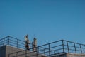 Mobile towers on the roof of a multi-level parking lot at dawn