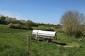 Mobile water barrel on wheels stands in a meadow