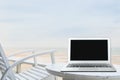 Mobile work office on the beach with blank laptop screen Royalty Free Stock Photo