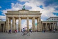 Mobility in Berlin, Germany. Bike passing in front of the Brandenburg Gate