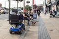 Mobility scooter for disabled person parked on the pavement sidewalk