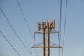 Mobility telecom panel antennas on the top of a power line lattice tower, in late afternoon light Royalty Free Stock Photo