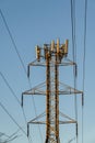 Mobility telecom panel antennas on the top of a power line lattice tower, in late afternoon light Royalty Free Stock Photo