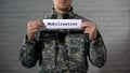 Mobilization word written on sign in male soldier hands, preparing for war