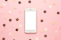 Moble phone with pink,gold and yellow confetti on pink color paper background minimal style