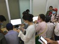 Unidentified Vietnamese citizens sign health declarations at the Moc Bai border point office to be transported to a quarantine fac