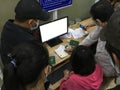 Unidentified Vietnamese citizens sign health declarations at the Moc Bai border point office to be transported to a quarantine fac