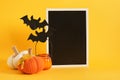 mocap black sign and halloween decor on a bright yellow background