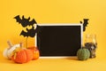 mocap black sign and halloween decor on a bright yellow background