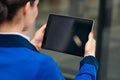 A mocap image of a woman sitting and holding a black tablet with the white desk screen off. Copy space for video communication Royalty Free Stock Photo