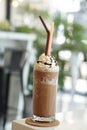 Close up of mocha coffee with whiped cream and nature bokeh background.