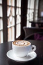 Mocha coffee drink on a wood table by the window