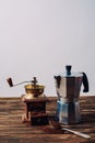 mocha pot and vintage coffee grinder on rustic Royalty Free Stock Photo
