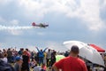 Mochishche airfield, local air show, yak 52 on blue sky with clouds background and many viewers, people watch aviashow