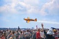Mochishche airfield, local air show, yellow Extra EX 360 sports plane and many viewers, people watch aviashow
