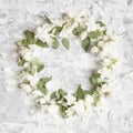 Mock orange wreath. Branches with flowers on shabby background.