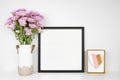 Mock up black frame with Mothers Day decor including vase of purple mum flowers and heart decor