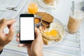 Mock up, black Smartphone in hand on a light food background. Calorie counting, weight tracking, and calorie foods